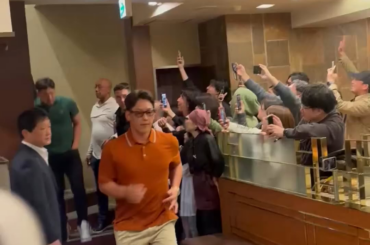 L'équipe japonaise entre et sort d'un restaurant Yakuniku